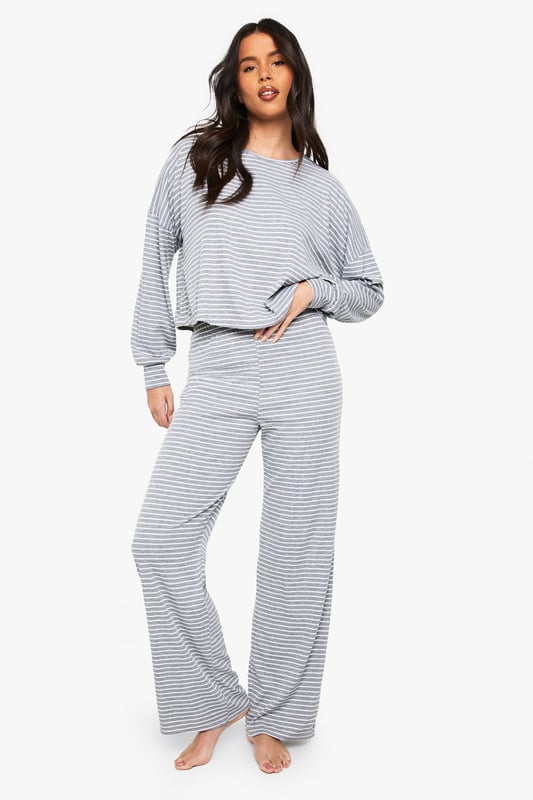 Soft jersey fabric with all-over stripe pattern for timeless loungewear appeal
        Relaxed crew neckline and long sleeves for ultimate comfort
        Cropped top design with slightly dropped shoulders for a contemporary silhouette
        Wide-leg trousers with comfortable waistband for unrestricted movement
        Coordinated two-piece set that can be styled together or separately
    
    This Boohoo loungewear set combines casual comfort with effortless style. The relaxed-fit jersey top features a modern cropped length that pairs perfectly with the matching wide-leg trousers, creating a coordinated look that's ideal for lazy weekends or working from home. The classic stripe pattern adds visual interest whilst maintaining versatility. Style with fluffy socks and your favourite oversized cardigan when temperatures drop, or wear the pieces separately to maximise your wardrobe options. The top works brilliantly with high-waisted jeans for casual outings, whilst the trousers can be paired with a fitted vest for warmer days. Perfect for those who value both comfort and style in their at-home wardrobe, this set transitions seamlessly from morning coffee to impromptu video calls without sacrificing your fashion credentials.