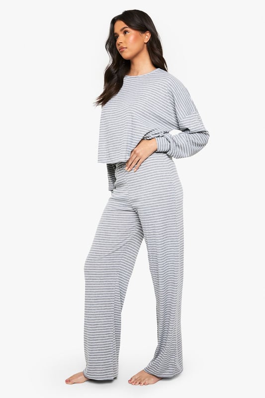 Soft jersey fabric with all-over stripe pattern for timeless loungewear appeal
        Relaxed crew neckline and long sleeves for ultimate comfort
        Cropped top design with slightly dropped shoulders for a contemporary silhouette
        Wide-leg trousers with comfortable waistband for unrestricted movement
        Coordinated two-piece set that can be styled together or separately
    
    This Boohoo loungewear set combines casual comfort with effortless style. The relaxed-fit jersey top features a modern cropped length that pairs perfectly with the matching wide-leg trousers, creating a coordinated look that's ideal for lazy weekends or working from home. The classic stripe pattern adds visual interest whilst maintaining versatility. Style with fluffy socks and your favourite oversized cardigan when temperatures drop, or wear the pieces separately to maximise your wardrobe options. The top works brilliantly with high-waisted jeans for casual outings, whilst the trousers can be paired with a fitted vest for warmer days. Perfect for those who value both comfort and style in their at-home wardrobe, this set transitions seamlessly from morning coffee to impromptu video calls without sacrificing your fashion credentials.
