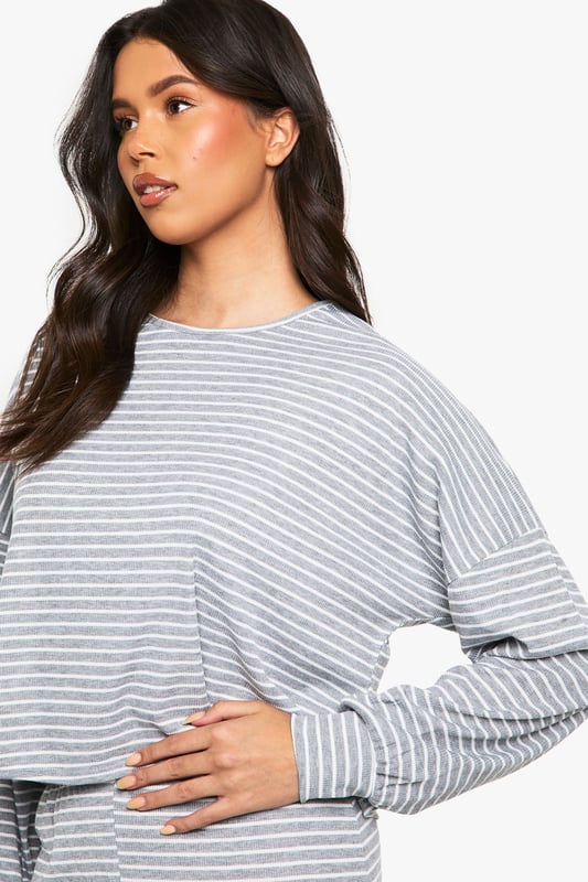 Soft jersey fabric with all-over stripe pattern for timeless loungewear appeal
        Relaxed crew neckline and long sleeves for ultimate comfort
        Cropped top design with slightly dropped shoulders for a contemporary silhouette
        Wide-leg trousers with comfortable waistband for unrestricted movement
        Coordinated two-piece set that can be styled together or separately
    
    This Boohoo loungewear set combines casual comfort with effortless style. The relaxed-fit jersey top features a modern cropped length that pairs perfectly with the matching wide-leg trousers, creating a coordinated look that's ideal for lazy weekends or working from home. The classic stripe pattern adds visual interest whilst maintaining versatility. Style with fluffy socks and your favourite oversized cardigan when temperatures drop, or wear the pieces separately to maximise your wardrobe options. The top works brilliantly with high-waisted jeans for casual outings, whilst the trousers can be paired with a fitted vest for warmer days. Perfect for those who value both comfort and style in their at-home wardrobe, this set transitions seamlessly from morning coffee to impromptu video calls without sacrificing your fashion credentials.