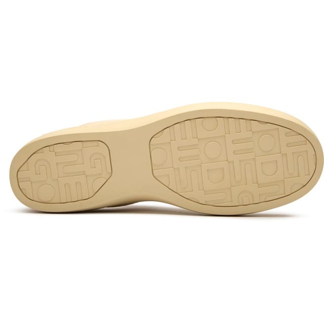 The Good News Lagoon trainers blend retro court styling with eco-conscious craftsmanship. These sand-colored kicks showcase handmade deadstock suede uppers with a distinctive stamped GN motif that adds subtle branding. The chunky organic cotton laces provide a textural contrast against the soft suede, while recycled mesh lining ensures breathable comfort. Perfect for the environmentally mindful gentleman seeking casual footwear with substance, these rubber-soled trainers deliver on both sustainability and laid-back style.