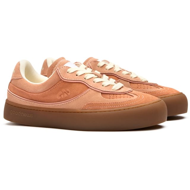 The GOOD NEWS Lagoon elevates everyday casual with its striking pink suede crafted from premium deadstock materials. These handmade court trainers balance eco-conscious design with street-ready style, featuring subtle stamped GN motifs and sturdy rubber soles for dependable grip. The chunky organic cotton laces add textural interest, while recycled mesh lining ensures breathable comfort. Perfect for the conscious consumer who refuses to sacrifice style for sustainability in their footwear selection.