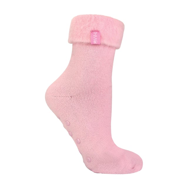 THMO Ladies Thermal Turnover Bed Socks: Embrace the cosy comfort of our THMO Bed Socks, your perfect pair for those chilly winter days and nights. As the temperature drops, it's essential to keep yourself warm while also saving on heating bills. Treat yourself to the ultimate warmth without compromising your budget. Crafted using a specially selected heavy bulk acrylic yarn, these socks possess exceptional thermal qualities that will keep your feet cosy even in the coldest of winters. To enhance their insulating properties, the socks have been double brushed on the inside, creating a plush and velvety texture that maximises warmth and provides softness against your skin. By effectively trapping warm air and enveloping your feet in comfort, these bed socks are the perfect choice for those moments of indoor relaxation and tranquillity. . An innovative anti-slip grip has been designed onto the foot of the sock in order to prevent you from slipping on surfaces such as hard wooden floors or kitchen tiles. . These THMO thermal bed socks are available in 3 colours: Purple, Pink & Blue, with dotted grippers. They are available in one size Ladies 4-8 UK. They are made from 93% Acrylic, 6% Polyamide & 1% Elastane. They are also safely machine washable. Extra Product Details: THMO Slipper Bed Socks Double Brushed Inner Thick & Warm Hand Linked Toe Turnover Top 3 Colour Options