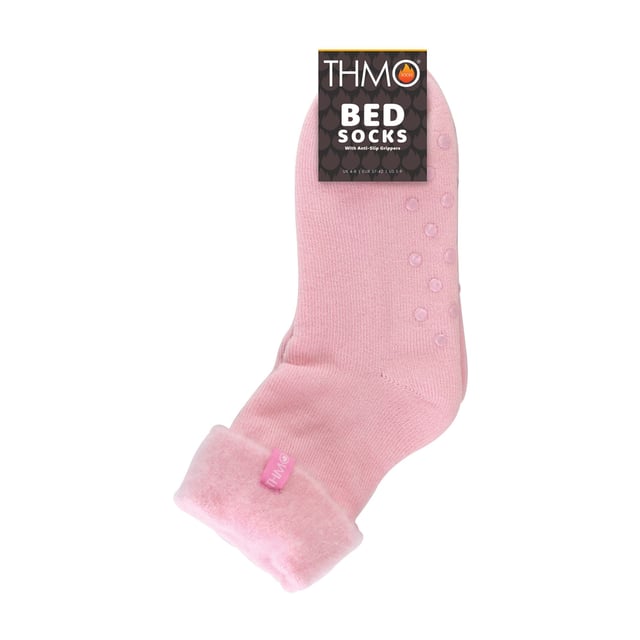 THMO Ladies Thermal Turnover Bed Socks: Embrace the cosy comfort of our THMO Bed Socks, your perfect pair for those chilly winter days and nights. As the temperature drops, it's essential to keep yourself warm while also saving on heating bills. Treat yourself to the ultimate warmth without compromising your budget. Crafted using a specially selected heavy bulk acrylic yarn, these socks possess exceptional thermal qualities that will keep your feet cosy even in the coldest of winters. To enhance their insulating properties, the socks have been double brushed on the inside, creating a plush and velvety texture that maximises warmth and provides softness against your skin. By effectively trapping warm air and enveloping your feet in comfort, these bed socks are the perfect choice for those moments of indoor relaxation and tranquillity. . An innovative anti-slip grip has been designed onto the foot of the sock in order to prevent you from slipping on surfaces such as hard wooden floors or kitchen tiles. . These THMO thermal bed socks are available in 3 colours: Purple, Pink & Blue, with dotted grippers. They are available in one size Ladies 4-8 UK. They are made from 93% Acrylic, 6% Polyamide & 1% Elastane. They are also safely machine washable. Extra Product Details: THMO Slipper Bed Socks Double Brushed Inner Thick & Warm Hand Linked Toe Turnover Top 3 Colour Options