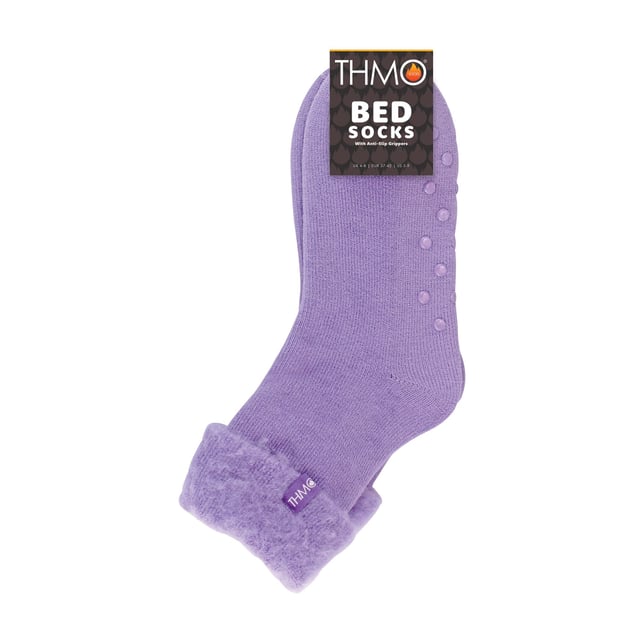 THMO Ladies Thermal Turnover Bed Socks: Embrace the cosy comfort of our THMO Bed Socks, your perfect pair for those chilly winter days and nights. As the temperature drops, it's essential to keep yourself warm while also saving on heating bills. Treat yourself to the ultimate warmth without compromising your budget. Crafted using a specially selected heavy bulk acrylic yarn, these socks possess exceptional thermal qualities that will keep your feet cosy even in the coldest of winters. To enhance their insulating properties, the socks have been double brushed on the inside, creating a plush and velvety texture that maximises warmth and provides softness against your skin. By effectively trapping warm air and enveloping your feet in comfort, these bed socks are the perfect choice for those moments of indoor relaxation and tranquillity. . An innovative anti-slip grip has been designed onto the foot of the sock in order to prevent you from slipping on surfaces such as hard wooden floors or kitchen tiles. . These THMO thermal bed socks are available in 3 colours: Purple, Pink & Blue, with dotted grippers. They are available in one size Ladies 4-8 UK. They are made from 93% Acrylic, 6% Polyamide & 1% Elastane. They are also safely machine washable. Extra Product Details: THMO Slipper Bed Socks Double Brushed Inner Thick & Warm Hand Linked Toe Turnover Top 3 Colour Options