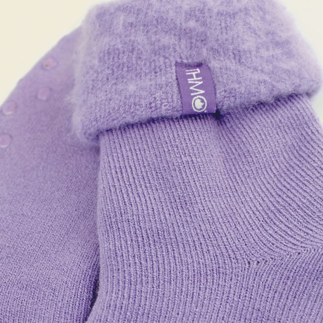 THMO Ladies Thermal Turnover Bed Socks: Embrace the cosy comfort of our THMO Bed Socks, your perfect pair for those chilly winter days and nights. As the temperature drops, it's essential to keep yourself warm while also saving on heating bills. Treat yourself to the ultimate warmth without compromising your budget. Crafted using a specially selected heavy bulk acrylic yarn, these socks possess exceptional thermal qualities that will keep your feet cosy even in the coldest of winters. To enhance their insulating properties, the socks have been double brushed on the inside, creating a plush and velvety texture that maximises warmth and provides softness against your skin. By effectively trapping warm air and enveloping your feet in comfort, these bed socks are the perfect choice for those moments of indoor relaxation and tranquillity. . An innovative anti-slip grip has been designed onto the foot of the sock in order to prevent you from slipping on surfaces such as hard wooden floors or kitchen tiles. . These THMO thermal bed socks are available in 3 colours: Purple, Pink & Blue, with dotted grippers. They are available in one size Ladies 4-8 UK. They are made from 93% Acrylic, 6% Polyamide & 1% Elastane. They are also safely machine washable. Extra Product Details: THMO Slipper Bed Socks Double Brushed Inner Thick & Warm Hand Linked Toe Turnover Top 3 Colour Options