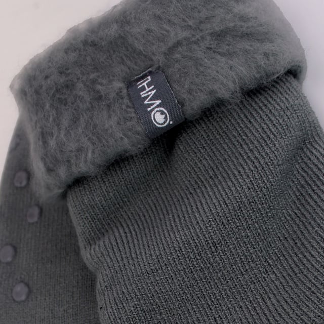 THMO Men’s Thermal Turnover Bed Socks: Embrace the cosy comfort of our THMO Bed Socks, your perfect pair for those chilly winter days and nights. As the temperature drops, it's essential to keep yourself warm while also saving on heating bills. Treat yourself to the ultimate warmth without compromising your budget. Crafted using a specially selected heavy bulk acrylic yarn, these socks possess exceptional thermal qualities that will keep your feet cosy even in the coldest of winters. . An innovative anti-slip grip has been designed onto the foot of the sock in order to prevent you from slipping on surfaces such as hard wooden floors or kitchen tiles. It is a simple but effective dotted design on the foot of the sock. By effectively trapping warm air and enveloping your feet in comfort, these bed socks are the perfect choice for those moments of indoor relaxation and tranquillity. The THMO badge is also heat transferred onto the side of the sock. These THMO thermal bed socks are available in 3 colours: Black, Navy & Charcoal, with dotted grippers. They are available in one size Men’s 6-11 UK. They are made from 93% Acrylic, 6% Polyamide & 1% Elastane. They are also safely machine washable. Extra Product Details: THMO Slipper Bed Socks Double Brushed Inner Thick & Warm Hand Linked Toe Turnover Top Non-Slip Grippers 3 Colour Options Men’s One Size 6-11 UK Machine Washable