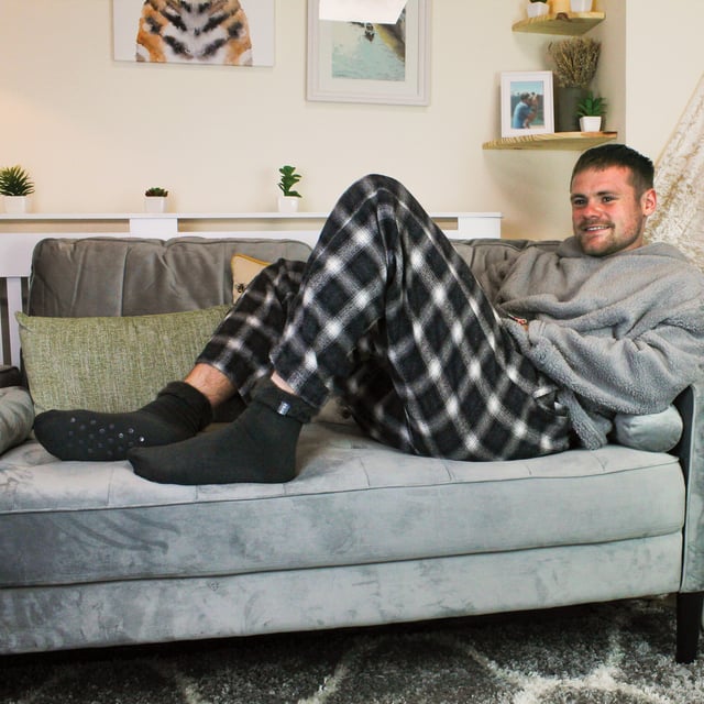 THMO Men’s Thermal Turnover Bed Socks: Embrace the cosy comfort of our THMO Bed Socks, your perfect pair for those chilly winter days and nights. As the temperature drops, it's essential to keep yourself warm while also saving on heating bills. Treat yourself to the ultimate warmth without compromising your budget. Crafted using a specially selected heavy bulk acrylic yarn, these socks possess exceptional thermal qualities that will keep your feet cosy even in the coldest of winters. . An innovative anti-slip grip has been designed onto the foot of the sock in order to prevent you from slipping on surfaces such as hard wooden floors or kitchen tiles. It is a simple but effective dotted design on the foot of the sock. By effectively trapping warm air and enveloping your feet in comfort, these bed socks are the perfect choice for those moments of indoor relaxation and tranquillity. The THMO badge is also heat transferred onto the side of the sock. These THMO thermal bed socks are available in 3 colours: Black, Navy & Charcoal, with dotted grippers. They are available in one size Men’s 6-11 UK. They are made from 93% Acrylic, 6% Polyamide & 1% Elastane. They are also safely machine washable. Extra Product Details: THMO Slipper Bed Socks Double Brushed Inner Thick & Warm Hand Linked Toe Turnover Top Non-Slip Grippers 3 Colour Options Men’s One Size 6-11 UK Machine Washable