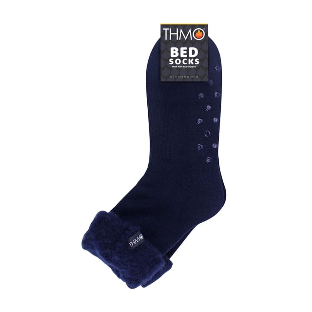 THMO Men’s Thermal Turnover Bed Socks: Embrace the cosy comfort of our THMO Bed Socks, your perfect pair for those chilly winter days and nights. As the temperature drops, it's essential to keep yourself warm while also saving on heating bills. Treat yourself to the ultimate warmth without compromising your budget. Crafted using a specially selected heavy bulk acrylic yarn, these socks possess exceptional thermal qualities that will keep your feet cosy even in the coldest of winters. . An innovative anti-slip grip has been designed onto the foot of the sock in order to prevent you from slipping on surfaces such as hard wooden floors or kitchen tiles. It is a simple but effective dotted design on the foot of the sock. By effectively trapping warm air and enveloping your feet in comfort, these bed socks are the perfect choice for those moments of indoor relaxation and tranquillity. The THMO badge is also heat transferred onto the side of the sock. These THMO thermal bed socks are available in 3 colours: Black, Navy & Charcoal, with dotted grippers. They are available in one size Men’s 6-11 UK. They are made from 93% Acrylic, 6% Polyamide & 1% Elastane. They are also safely machine washable. Extra Product Details: THMO Slipper Bed Socks Double Brushed Inner Thick & Warm Hand Linked Toe Turnover Top Non-Slip Grippers 3 Colour Options Men’s One Size 6-11 UK Machine Washable