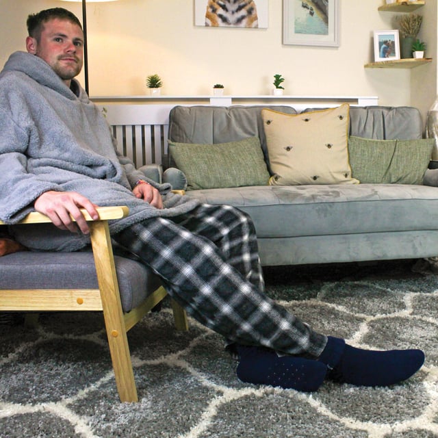 THMO Men’s Thermal Turnover Bed Socks: Embrace the cosy comfort of our THMO Bed Socks, your perfect pair for those chilly winter days and nights. As the temperature drops, it's essential to keep yourself warm while also saving on heating bills. Treat yourself to the ultimate warmth without compromising your budget. Crafted using a specially selected heavy bulk acrylic yarn, these socks possess exceptional thermal qualities that will keep your feet cosy even in the coldest of winters. . An innovative anti-slip grip has been designed onto the foot of the sock in order to prevent you from slipping on surfaces such as hard wooden floors or kitchen tiles. It is a simple but effective dotted design on the foot of the sock. By effectively trapping warm air and enveloping your feet in comfort, these bed socks are the perfect choice for those moments of indoor relaxation and tranquillity. The THMO badge is also heat transferred onto the side of the sock. These THMO thermal bed socks are available in 3 colours: Black, Navy & Charcoal, with dotted grippers. They are available in one size Men’s 6-11 UK. They are made from 93% Acrylic, 6% Polyamide & 1% Elastane. They are also safely machine washable. Extra Product Details: THMO Slipper Bed Socks Double Brushed Inner Thick & Warm Hand Linked Toe Turnover Top Non-Slip Grippers 3 Colour Options Men’s One Size 6-11 UK Machine Washable