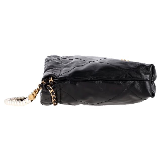 VINTAGE, RRP AS NEW
The Chanel 22 Quilted Mini Bag in Black Shiny Calfskin is the ultimate fusion of heritage and modernity. Crafted in supple diamond-stitched calfskin and finished with aged gold hardware, this mini marvel exudes effortless Parisian chic. The iconic Chanel logo, leather-threaded chain strap, and medallion charm lend a luxurious touch to a piece that’s both light and bold in personality.


Chanel 22 Quilted Mini Hobo Bag in Black Shiny Calfskin Leather
Condition: Excellent
Signs of wear: No retail tag, No visible sign of wear., 
Packaging: None
Color: black
Material: Leather | leather
Size: One Size | One Size
Measurements: Width: 70; Height: 190; Length: 230
SKU: NAPPUGBBA512640W