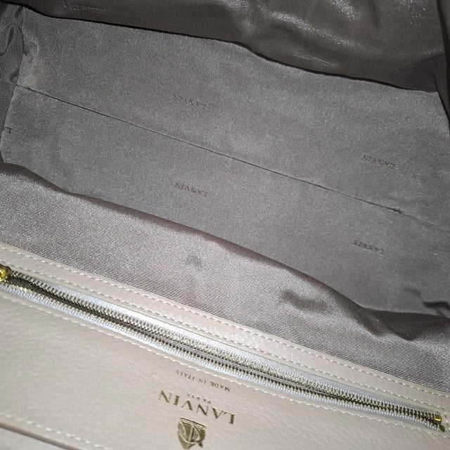 VINTAGE, RRP AS NEW
The Lanvin Large Partition Chain Shoulder Bag in beige and black leather blends timeless elegance with modern functionality, featuring a structured silhouette and gleaming gold-tone chain strap. Its spacious, multi-compartment interior makes it perfect for staying organized in style. **Style tip:** Carry it with a neutral-toned trench and wide-leg trousers for a sophisticated, city-chic look that transitions effortlessly from day to night.

 Lanvin Large Partition Chain Shoulder Bag in Beige and Black Leather

Condition: Excellent
Signs of wear: No retail tag, No visible sign of wear., 
Packaging: None
Color: Beige
Material: Leather |  leather
Size: One Size | One Size
Measurements: Width: 110; Height: 180; Length: 330; Handle drop: 280; Strap length: 0
SKU: NAPPUGBBA524340W