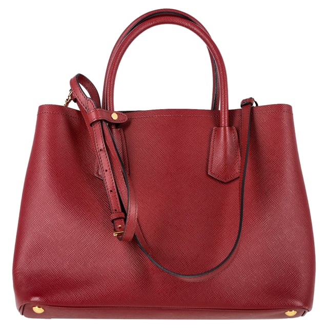 VINTAGE, RRP AS NEW
The Prada Double Handle Tote in rich Cerise red Saffiano leather (BN2775) is the perfect blend of sophistication and function. Crafted from iconic cross-hatched Saffiano leather, it features rolled top handles, gold-tone logo detailing, and a spacious, dual-compartment interior with a center snap pocket—ideal for organizing work or daily essentials. Its structured silhouette makes it a timeless, go-anywhere companion.


Prada Double Handle Tote Bag in Red Saffiano Leather
Condition: Excellent
Signs of wear: No retail tag, No visible sign of wear., 
Packaging: Dust bag
Color: Red 
Material: Leather | leather
Size: One Size | One Size
Measurements: Width: 150; Height: 240; Length: 340; Handle drop: 120; Strap length: 1200
SKU: NAPPUGBBA506565W