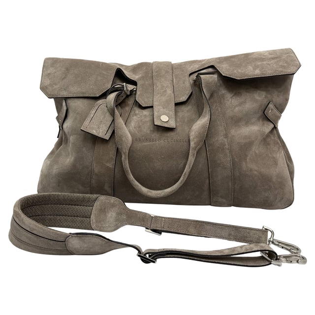 VINTAGE, RRP AS NEW
Elevate your travel style with the Brunello Cucinelli Weekend Bag, expertly crafted in supple grey suede for a luxurious yet laid-back aesthetic. Its spacious interior and refined detailing make it the perfect companion for effortless weekend getaways. **Style Tip:** Pair it with a wool overcoat and leather sneakers for a polished, jet-set-ready look.

 Brunello Cucinelli Weekend Bag in Grey Suede

Condition: Very good
Signs of wear: Lightly used but very well maintained. Minor creasing, light worn corners, light scratches., Minor sign of wear or markings.
Packaging: Dust bag
Color: Grey
Material: Suede | suede
Size: One Size | One Size
Measurements: Handle drop: 550 mm; Strap length: 860 mm
SKU: MRPPUGBBA508690M