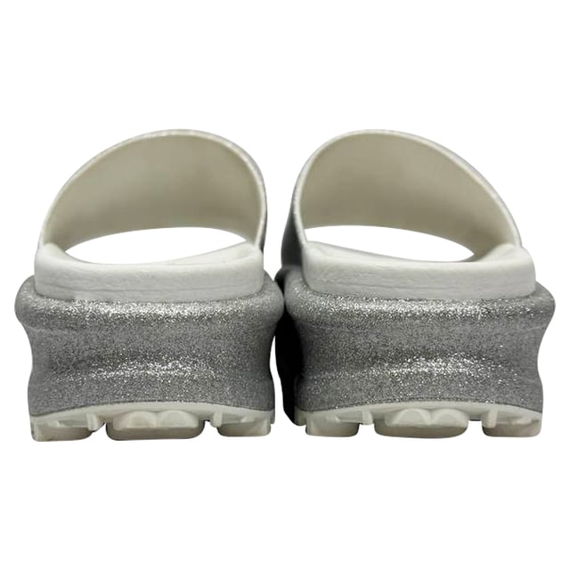 VINTAGE, RRP AS NEW
Step into effortless glamour with the Gucci GG Logo Glittered Slide Sandals in Silver Rubber — where iconic luxury meets eye-catching sparkle. These chic slides elevate any casual look, perfect for adding a touch of shine to your weekend outfit. **Styling tip:** Pair them with cropped denim and a sleek white blouse for an effortlessly polished vibe that highlights the sandals’ dazzling silver glitter.

 Gucci GG Logo Glittered Slide Sandals in Silver Rubber

Condition: Very good
Signs of wear: Minor markings, Lightly used but very well maintained. Minor mark at soles & creasing, light scuffing at the soles and heels.
Packaging: Box
Color: Metallic | silver
Material: Rubber
Size: IT | 34
Measurements: Insole length: 250 mm
SKU: TONPUGBSH524165W