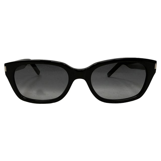 VINTAGE, RRP AS NEW
The Saint Laurent SL522 Square‑Frame Sunglasses in glossy black acetate showcase a bold, sculptural silhouette with refined metal bridge detailing—effortlessly blending modern confidence with Parisian chic. Their oversized square lenses offer optimal sun protection while accentuating sharp jawlines and structured styles. Complete your look by pairing them with a crisp white tee, tailored blazer, and dark wash denim—or slip into a sleek tailored suit and add these sunglasses for a striking, head-turning finishing touch.

Saint Laurent SL522 Square Frame Sunglasses in Black Acetate

Condition: Excellent
Signs of wear:  No sign of wear.
Packaging: None
Color: Black
Material: Plastic
Size: One size
Measurements: Frame width 150 mm Height 155 mm
SKU: MRPPUGBAC511291W