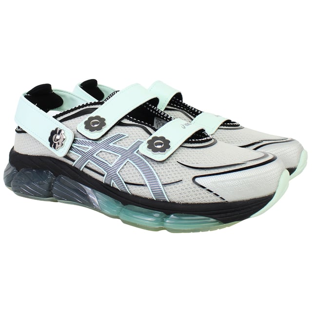 The ASICS × Cecilie Bahnsen Gel‑Quantum 360 VIII trainers blend cutting-edge sports performance with couture-level design. This limited-edition collaboration reimagines ASICS’ iconic full-GEL cushioning in a sandal-style silhouette featuring sculptural velcro straps adorned with delicate floral motifs. Crafted in a sophisticated grey palette, these trainers offer a wearable yet refined aesthetic that bridges athletic functionality with feminine elegance.
Key Features
Division Space Midsole Technology

Incorporates space between the GEL and midsole layers, delivering lightweight cushioning and enhanced responsiveness 

Full-Length GEL® 360 Cushioning

Surrounds the foot in cushioned support, providing superior shock absorption and plush comfort with every step 

FF Blast Plus ECO Foam

Utilizes eco-friendly foam with at least 20% sugarcane-derived biomass for resilience and sustainable performance 

5D Printed Mesh Upper

Tech-inspired, two-tone mesh base enhanced with three-dimensional prints that mimic organic, ergonomic structures 

Sandal-Inspired Velcro Straps

Three adjustable straps—including two Mary Jane style and one heel strap—each accented with metal flower embellishments for both decoration and secure fit 

Semi‑Transparent Rubber Outsole

Reveals a floral print nestled under the sole, blending design artistry with practical traction 

Advanced TRUSSTIC™ &amp; External Heel Counter

Integrated stability solutions provide structure and dynamic support during movement.