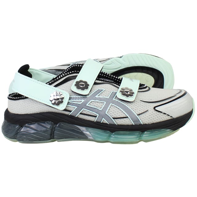 The ASICS × Cecilie Bahnsen Gel‑Quantum 360 VIII trainers blend cutting-edge sports performance with couture-level design. This limited-edition collaboration reimagines ASICS’ iconic full-GEL cushioning in a sandal-style silhouette featuring sculptural velcro straps adorned with delicate floral motifs. Crafted in a sophisticated grey palette, these trainers offer a wearable yet refined aesthetic that bridges athletic functionality with feminine elegance.
Key Features
Division Space Midsole Technology

Incorporates space between the GEL and midsole layers, delivering lightweight cushioning and enhanced responsiveness 

Full-Length GEL® 360 Cushioning

Surrounds the foot in cushioned support, providing superior shock absorption and plush comfort with every step 

FF Blast Plus ECO Foam

Utilizes eco-friendly foam with at least 20% sugarcane-derived biomass for resilience and sustainable performance 

5D Printed Mesh Upper

Tech-inspired, two-tone mesh base enhanced with three-dimensional prints that mimic organic, ergonomic structures 

Sandal-Inspired Velcro Straps

Three adjustable straps—including two Mary Jane style and one heel strap—each accented with metal flower embellishments for both decoration and secure fit 

Semi‑Transparent Rubber Outsole

Reveals a floral print nestled under the sole, blending design artistry with practical traction 

Advanced TRUSSTIC™ &amp; External Heel Counter

Integrated stability solutions provide structure and dynamic support during movement.