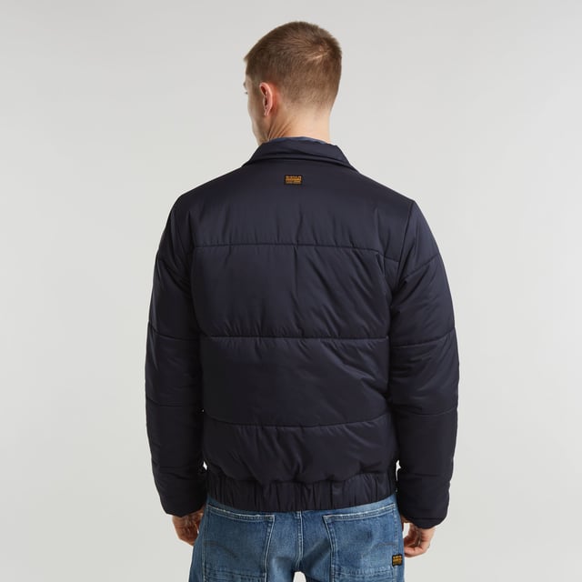 Raised collar. Zipper closure. Welt pockets at the waist, hidden snap button. Elasticated inner cuffs. Hanger loop inside. Zip closure. Padded jacket Quilted fis designed in a straight fit and offers a raised collar. Welt pockets at the waist are secured with a hidden snap button. An elasticated hemline and inner cuffs add to a comfortable fit. 100% Polyester (Recycled). Woven