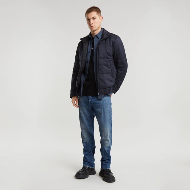 Raised collar. Zipper closure. Welt pockets at the waist, hidden snap button. Elasticated inner cuffs. Hanger loop inside. Zip closure. Padded jacket Quilted fis designed in a straight fit and offers a raised collar. Welt pockets at the waist are secured with a hidden snap button. An elasticated hemline and inner cuffs add to a comfortable fit. 100% Polyester (Recycled). Woven