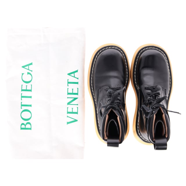 VINTAGE, RRP AS NEW
Command attention with the Bottega Veneta Bounce Mid-Calf Combat Boots, crafted from luxurious calf leather and set on a bold, sculptural sole for a powerful silhouette. These elevated combat boots combine utilitarian edge with Italian craftsmanship, delivering both comfort and high-fashion impact. **Styling tip:** Wear them with an oversized blazer and mini dress or tuck in relaxed trousers for a confident, street-style-ready look.

 Bottega Veneta Bounce Mid-Calf Combat Boots in Calf Leather

Condition: Very good
Signs of wear: Lightly used but very well maintained. Minor mark at soles & creasing, light scuffing at the soles and heels., Minor markings
Packaging: Dust bag
Color: Black
Material: Leather | calfskin leather
Size: EU | 37
Measurements: Insole length: 240
SKU: NAPPUDESH511927W