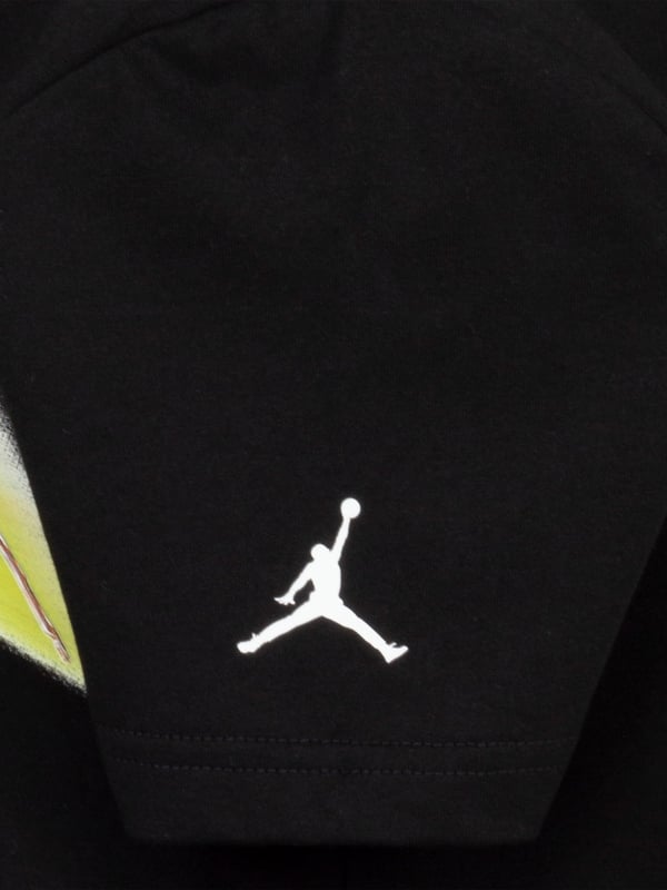 Introducing the SS2025 Jordan Boys Sports Graphic T-Shirt in sleek black, a quintessential addition to any young wardrobe. Crafted with pinnacle quality, this piece is not just a t-shirt, it's a style statement. Sophisticated Design Features a dynamic, sports-inspired graphic that captures the essence of youthful energy. Luxurious Comfort Expertly made from premium fabric to ensure softness and durability for all-day wear. Versatile Appeal Perfect for both sports and casual outings, ensuring your boy always looks his best. Elevate his style with this exclusive Jordan piece.
