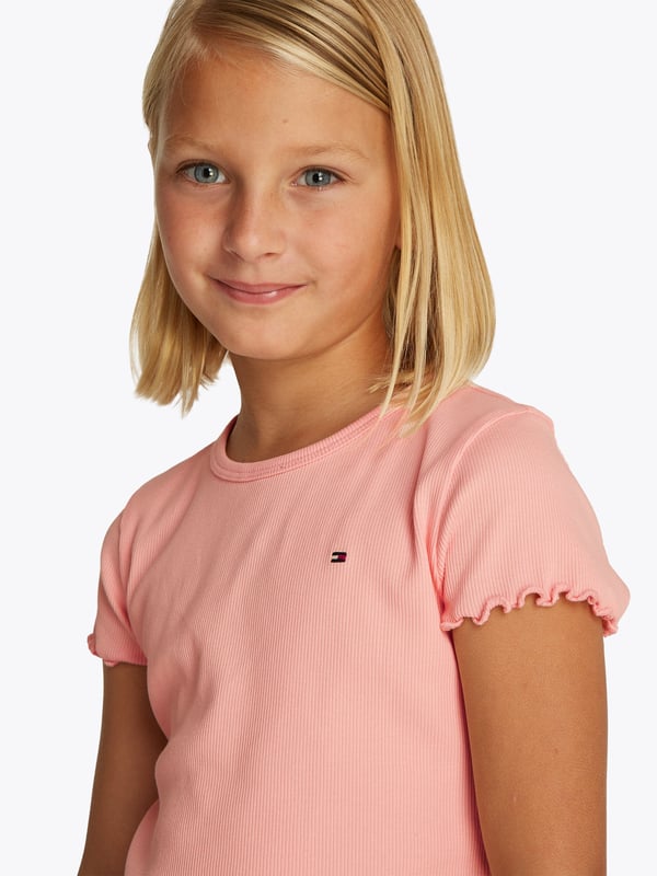 Introducing the exquisite Tommy Hilfiger Girls Essential Rib Top in Pink a quintessential addition for the discerning young lady's SS2025 wardrobe. Elegantly Tailored Crafted with precision, this top features a chic, snug fit that accentuates a graceful silhouette. Vibrant Pink Hue Radiating charm, its delightful pink shade ensures your girl shines on every occasion. Premium Fabric Soft, stretchable ribbed fabric guarantees comfort while offering durability for all-day play.Refine her style with Tommy Hilfiger's timeless elegance. Perfect for any event where fashion and comfort must go hand-in-hand.