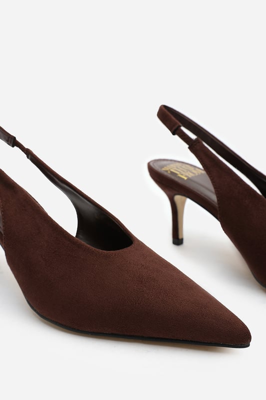 Wheres That From Womens 'Nora' Pointed Slingback Kitten Heels Step out in elegance with these Nora Pointed Slingback Kitten Heels, crafted in soft faux suede for a timeless finish. The pointed toe and low heel create a flattering, feminine silhouette perfect for day-to-night wear. Designed with a comfortable slingback strap, these heels pair effortlessly with dresses, trousers, or tailored sets. Key Features: • Material: Faux suede upper with smooth lining • Design: Pointed toe with slingback and kitten heel • Closure: Slip-on style with elasticated sling strap