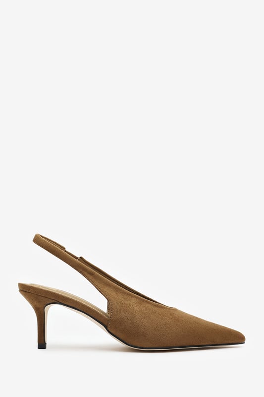 Step out in elegance with these Nora Pointed Slingback Kitten Heels, crafted in soft faux suede for a timeless finish. The pointed toe and low heel create a flattering, feminine silhouette perfect for day-to-night wear. Designed with a comfortable slingback strap, these heels pair effortlessly with dresses, trousers, or tailored sets. Key Features: • Material: Faux suede upper with smooth lining • Design: Pointed toe with slingback and kitten heel • Closure: Slip-on style with elasticated sling strap