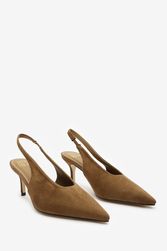 Step out in elegance with these Nora Pointed Slingback Kitten Heels, crafted in soft faux suede for a timeless finish. The pointed toe and low heel create a flattering, feminine silhouette perfect for day-to-night wear. Designed with a comfortable slingback strap, these heels pair effortlessly with dresses, trousers, or tailored sets. Key Features: • Material: Faux suede upper with smooth lining • Design: Pointed toe with slingback and kitten heel • Closure: Slip-on style with elasticated sling strap