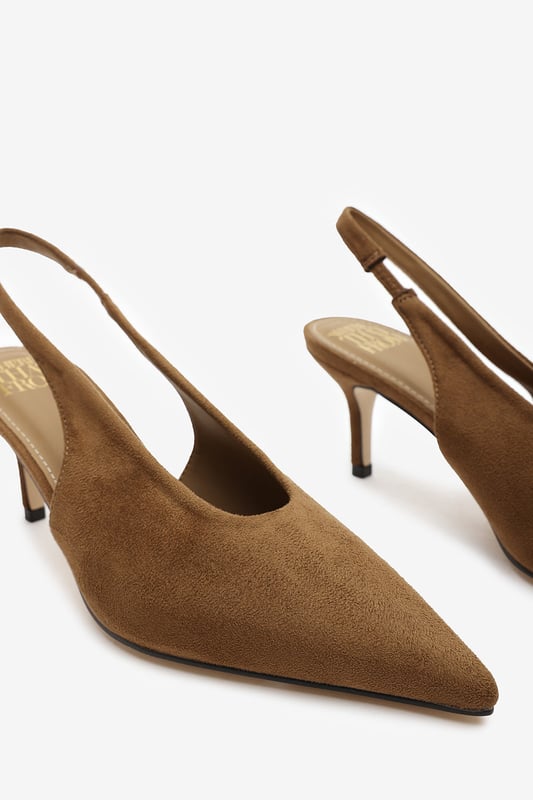 Step out in elegance with these Nora Pointed Slingback Kitten Heels, crafted in soft faux suede for a timeless finish. The pointed toe and low heel create a flattering, feminine silhouette perfect for day-to-night wear. Designed with a comfortable slingback strap, these heels pair effortlessly with dresses, trousers, or tailored sets. Key Features: • Material: Faux suede upper with smooth lining • Design: Pointed toe with slingback and kitten heel • Closure: Slip-on style with elasticated sling strap