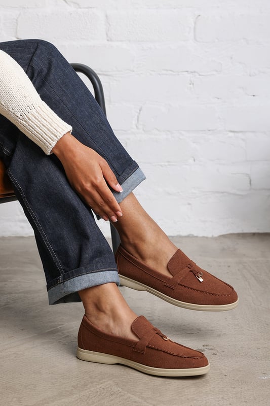 Wheres That From Womens 'Pegasus' Slip On Trim Loafers With Accessory Detailing Stay effortlessly chic in our Pegasus Slip On Trim Loafers, crafted in soft faux suede with a playful front accessory. Designed for everyday elegance, these loafers feature a cushioned memory foam insole and breathable lining for all-day comfort. The slip-on design and rubber sole offer ease and traction, making them perfect for work, weekends, or casual evenings out. Key Features: • Material: Faux suede upper with breathable, odor-resistant foam lining • Design: Flat dolly sliders with charm accessory detail • Closure: Easy slip-on design