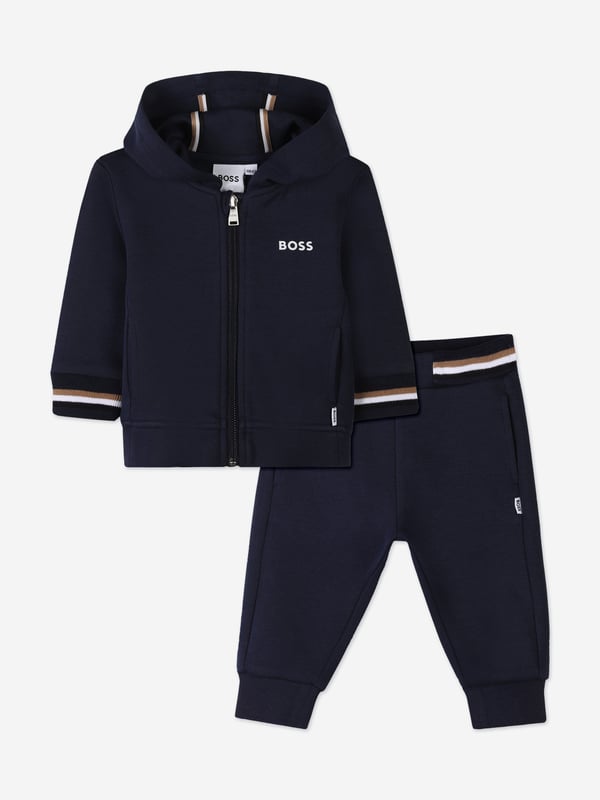 Unveil the epitome of style and comfort with the BOSS Baby Boys Logo Print Tracksuit in Navy, a sublime addition to your little one's SS2025 wardrobe. Crafted with precision, this ensemble offers a harmonious blend of elegance and playfulness Iconic BOSS Print Features a distinctive logo print, elevating your child's style quotient. Premium Comfort Crafted from luxurious fabrics, ensuring all-day ease and comfort. Versatile Navy Hue A sophisticated shade that complements any occasion.Refresh your child's collection with this chic, timeless tracksuit.