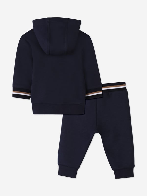 Unveil the epitome of style and comfort with the BOSS Baby Boys Logo Print Tracksuit in Navy, a sublime addition to your little one's SS2025 wardrobe. Crafted with precision, this ensemble offers a harmonious blend of elegance and playfulness Iconic BOSS Print Features a distinctive logo print, elevating your child's style quotient. Premium Comfort Crafted from luxurious fabrics, ensuring all-day ease and comfort. Versatile Navy Hue A sophisticated shade that complements any occasion.Refresh your child's collection with this chic, timeless tracksuit.