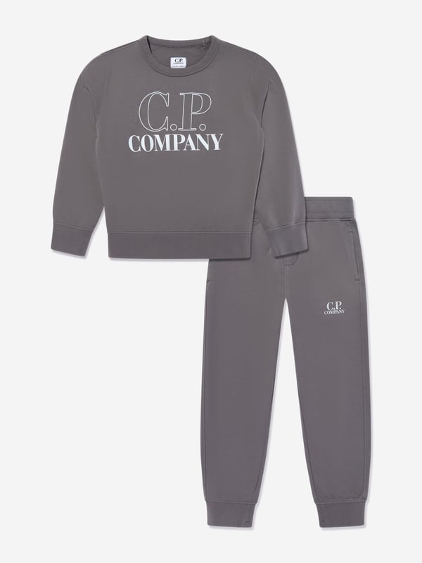 Elevate your young gentleman's ensemble with the CP Company Boys Logo Tracksuit in Grey. Expertly crafted for SS2025, this tracksuit is the pinnacle of luxury and utility. Iconic Lens Detail Celebrated CP Company lens on the sleeve adds a distinctive touch. Premium Comfort Constructed from superior quality fabrics, ensuring comfort during any activity. Subtle Branding Understated logo detailing offers a chic and elegant look. Versatile Style Ideal for both casual outings and stylish lounging at home.Refresh his wardrobe with flair sophistication! Order today.