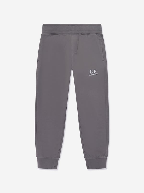 Elevate your young gentleman's ensemble with the CP Company Boys Logo Tracksuit in Grey. Expertly crafted for SS2025, this tracksuit is the pinnacle of luxury and utility. Iconic Lens Detail Celebrated CP Company lens on the sleeve adds a distinctive touch. Premium Comfort Constructed from superior quality fabrics, ensuring comfort during any activity. Subtle Branding Understated logo detailing offers a chic and elegant look. Versatile Style Ideal for both casual outings and stylish lounging at home.Refresh his wardrobe with flair sophistication! Order today.