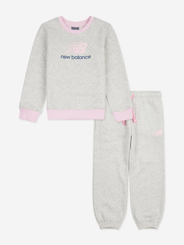 New Balance Girls Logo Tracksuit in Grey Discover the elegance practicality of the New Balance Apparel Girls Logo Tracksuit in Grey, an impeccable choice for SS2025. Crafted meticulously for chic young ladies, this tracksuit merges fashion with function Iconic Brand Motif Stylized New Balance logo ensures a fashionable edge with every outing. Luxurious Comfort Constructed from premium fabrics for a soft, comfortable fit perfect for daily adventures. Stylish Versatility Ideal for both sporty pursuits and casual outings, enhancing any girls wardrobe seamlessly.Elevate her style this season with this exclusive piece. Order now indulge in the blend of comfort and chic design!