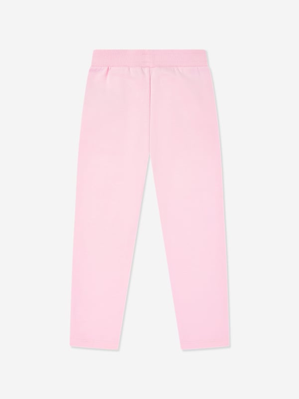 Balmain embody distinctive Parisian sensibilities in their immaculate designs. These girls pink gold joggers are reflective of the label's passion for raw innovation. Made in the finest cotton jersey with embellished gold buttons, a ribbed elasticated waistband, and front short side pockets. Straight Hem 100 Cotton Trim 95 Cotton, 5 Elastane