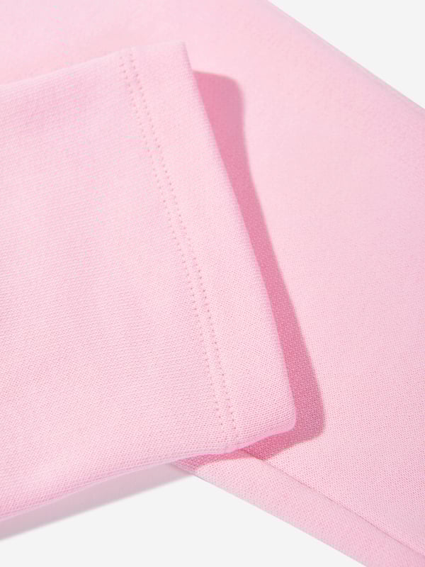Balmain embody distinctive Parisian sensibilities in their immaculate designs. These girls pink gold joggers are reflective of the label's passion for raw innovation. Made in the finest cotton jersey with embellished gold buttons, a ribbed elasticated waistband, and front short side pockets. Straight Hem 100 Cotton Trim 95 Cotton, 5 Elastane