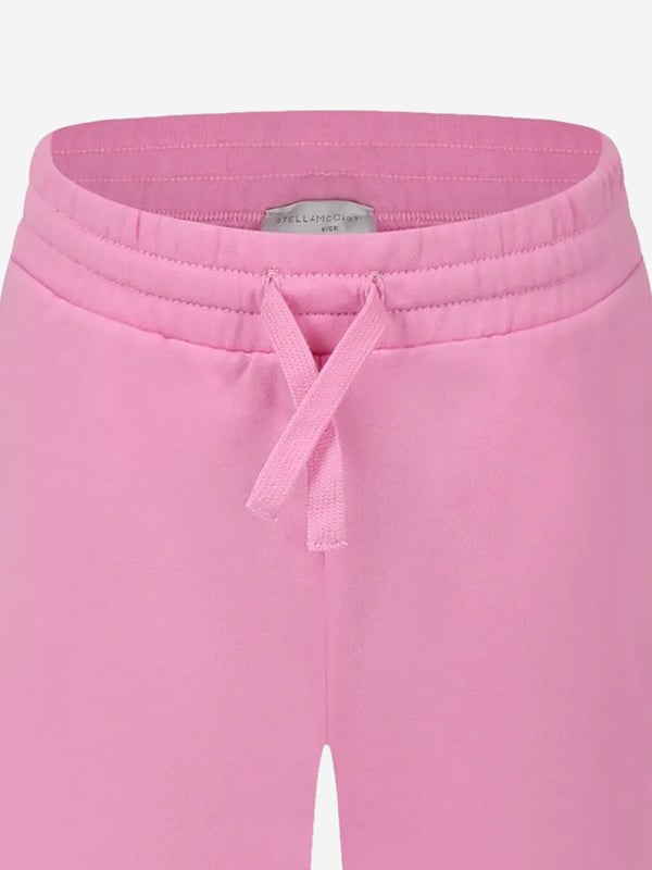 Introducing the sublime Stella McCartney Girls Logo Joggers in Pink an essential enhancement for your girl's wardrobe this SS2025. Meticulously tailored, each feature ensures a harmonious blend of elegance and comfort Chic Pink Shade Exude sophistication with the iconic pink hue, complementing any look with effortless charm. Signature Logo Detail Stella's revered branding accentuates these joggers, adding a distinctive touch of luxury. Premium Fabric Crafted from superior materials, ensuring both sustainability and softness for delicate skin.Revitalise her ensemble with this pink perfection. Purchase todaywhere style meets comfort.