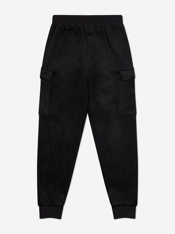 Introducing the Girls Cargo Cuffed Joggers in Black from Juicy Couture, a quintessential addition to your girl's wardrobe for SS2025. Elegantly tailored to blend sophistication with casual comfort, these joggers redefine childrens fashion. Key highlights include Luxe Comfort Crafted from premium fabric, ensuring softness durability. Chic Detailing Sleek cargo pockets cuffed ankles fuse functionality with style. Versatile Black Hue Perfect for seamless pairing with any top or accessory.Elevate your girls style quotient with these Joggers a symbol of modern chic!