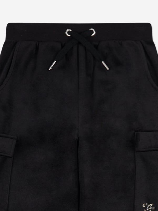 Introducing the Girls Cargo Cuffed Joggers in Black from Juicy Couture, a quintessential addition to your girl's wardrobe for SS2025. Elegantly tailored to blend sophistication with casual comfort, these joggers redefine childrens fashion. Key highlights include Luxe Comfort Crafted from premium fabric, ensuring softness durability. Chic Detailing Sleek cargo pockets cuffed ankles fuse functionality with style. Versatile Black Hue Perfect for seamless pairing with any top or accessory.Elevate your girls style quotient with these Joggers a symbol of modern chic!