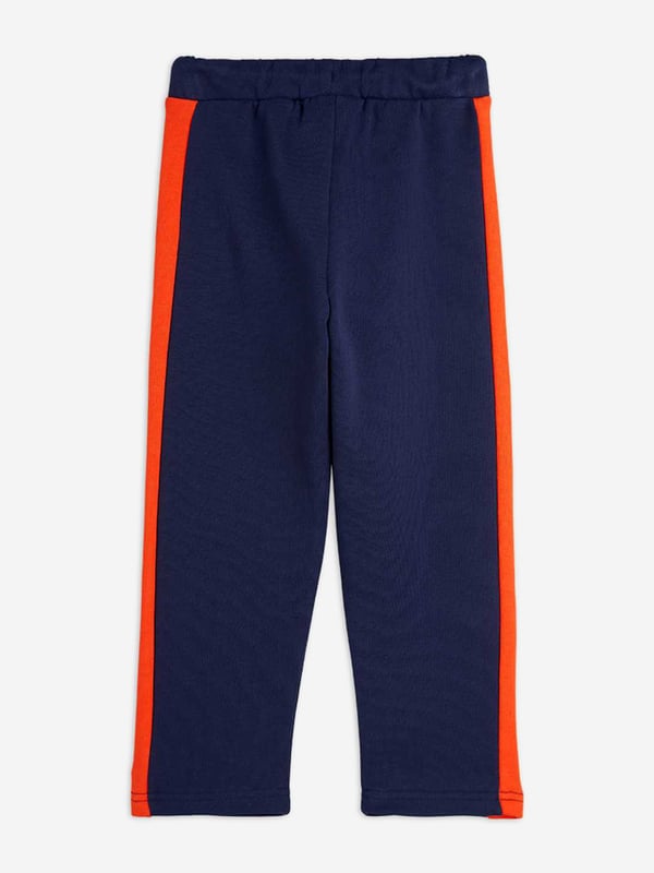 Introducing the Boys Panel Embroidered Joggers in Navy by mini rodini, a quintessential addition for your boy's wardrobe for SS2025. Merging sophistication with playfulness, these joggers epitomize high-end comfort with a dash of flair. Key features include Exquisite Embroidery Elegant detailing that elevates the everyday. Premium Fabric Crafted in luxurious, breathable materials. Versatile Navy Hue Perfect for mixing and matching. Refresh your child's attire with a touch of designer charm shop these joggers today!