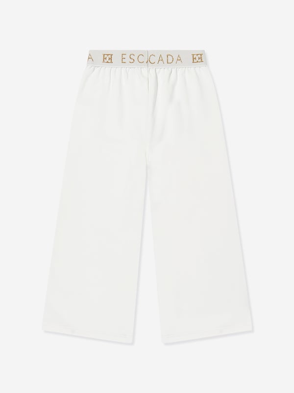 Escada incorporate high standards of elegance and unbeatable glamour into their aesthetics. These girls snow white joggers are woven in beautiful high quality with a tape elasticated waistband and Escada golden print. Straight Hem 95 Cotton, 5 Elastane