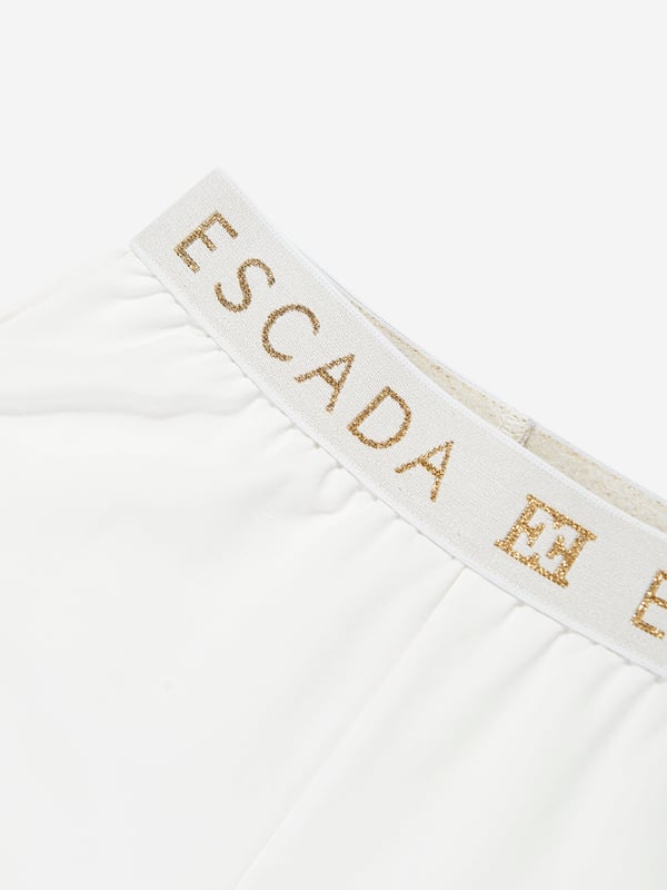 Escada incorporate high standards of elegance and unbeatable glamour into their aesthetics. These girls snow white joggers are woven in beautiful high quality with a tape elasticated waistband and Escada golden print. Straight Hem 95 Cotton, 5 Elastane