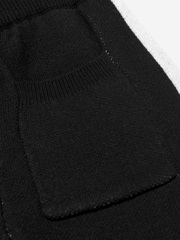 The Couture Club embody innovation and sophistication in their streetwear portraits. These kids side stripe knitted joggers in black are made from beautiful high quality. Functional Welt Pocket to Back Straight Leg Knitted Joggers Wide Contrast Panelling Ribbed Waistband With Drawcords Embroidered Contrast Logo to Front Left Leg Ribbed Welt Side Pockets 100 Cotton