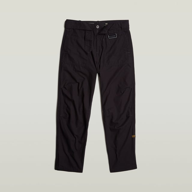 Zip fly. Side seam pockets, patched-on waist pockets. Flap pockets at the back, snap buttons. Belt. Adjustable leg width, tab. Button & zip closure. Mid waist. This Fatigue pant is designed in a relaxed tapered fit. The pleats at the side and the tabs at the ankle add to it. These pants combine side seam pockets with pockets at the front. The backside shows flap pockets with a snap button closure. Use the belt to finetune the fit. 100% Cotton. Rigid. Tapered