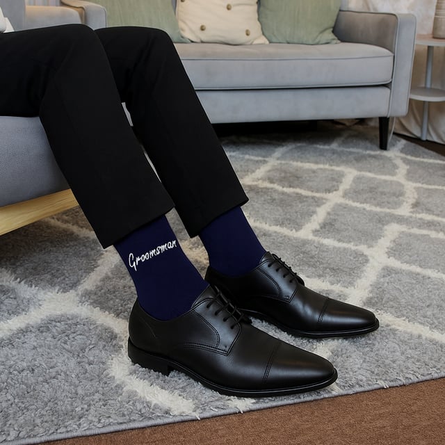Sock Snob - 1 Pack Mens Wedding Socks: Add a touch of elegance to your wedding day with the Sock Snob 1 Pack Mens Wedding Socks. Designed specifically for key members of the wedding party, these socks are available with personalized labels for Groomsman, Groom, Father of the Groom, Father of the Bride, and Best Man. Choose from classic Navy or Black to perfectly complement your wedding attire. Sized to fit 6-11, these socks provide comfort and style for all-day wear. Made from high-quality, breathable fabric, these socks ensure a soft and luxurious feel, making them ideal for long hours of celebration. Whether you're walking down the aisle, posing for photos, or dancing the night away, these socks are crafted for durability and elegance. These socks also make for a meaningful gift, allowing you to honor the important men in your life with a keepsake they’ll cherish. The timeless design and personalized touch make them suitable for weddings, formal events, or as a thoughtful gesture. Extra Product Details: Styles: Groomsman, Groom, Father of the Groom, Father of the Bride, Best Man Colours: Navy, Black Sizes: 6-11 Material: High-quality, breathable fabric Includes: 1 pair of wedding socks Machine washable for easy care. Elegant, practical, and timeless, Sock Snob Wedding Socks are the perfect choice for your special day. Celebrate in comfort and style while creating lasting memories with these premium socks.
