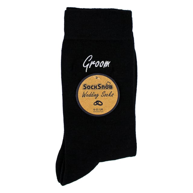 Sock Snob - 1 Pack Mens Wedding Socks: Add a touch of elegance to your wedding day with the Sock Snob 1 Pack Mens Wedding Socks. Designed specifically for key members of the wedding party, these socks are available with personalized labels for Groomsman, Groom, Father of the Groom, Father of the Bride, and Best Man. Choose from classic Navy or Black to perfectly complement your wedding attire. Sized to fit 6-11, these socks provide comfort and style for all-day wear. Made from high-quality, breathable fabric, these socks ensure a soft and luxurious feel, making them ideal for long hours of celebration. Whether you're walking down the aisle, posing for photos, or dancing the night away, these socks are crafted for durability and elegance. These socks also make for a meaningful gift, allowing you to honor the important men in your life with a keepsake they’ll cherish. The timeless design and personalized touch make them suitable for weddings, formal events, or as a thoughtful gesture. Extra Product Details: Styles: Groomsman, Groom, Father of the Groom, Father of the Bride, Best Man Colours: Navy, Black Sizes: 6-11 Material: High-quality, breathable fabric Includes: 1 pair of wedding socks Machine washable for easy care. Elegant, practical, and timeless, Sock Snob Wedding Socks are the perfect choice for your special day. Celebrate in comfort and style while creating lasting memories with these premium socks.