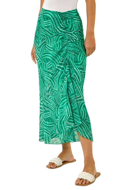 Marked Ruffle Midi Skirt from Roman. Make a stylish statement this Spring/Summer with this marked ruffle skirt. This midi length skirt is designed with a unique ruffle detail that adds a playful touch to your outfit. The side zip fastening ensures a sleek, flattering fit while making it easy to slip on and off. Pair it with a chic cami top and trendy sandals for a fabulous look that's perfect for any sunny day outing!
