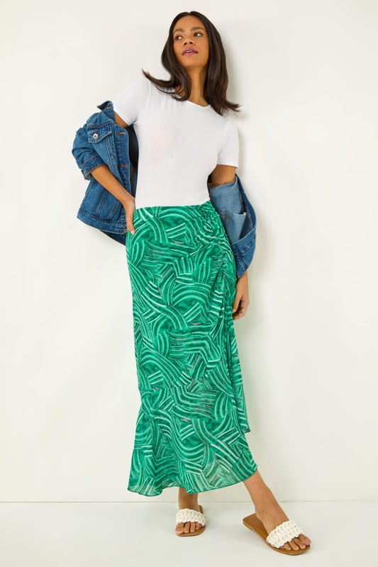 Marked Ruffle Midi Skirt from Roman. Make a stylish statement this Spring/Summer with this marked ruffle skirt. This midi length skirt is designed with a unique ruffle detail that adds a playful touch to your outfit. The side zip fastening ensures a sleek, flattering fit while making it easy to slip on and off. Pair it with a chic cami top and trendy sandals for a fabulous look that's perfect for any sunny day outing!